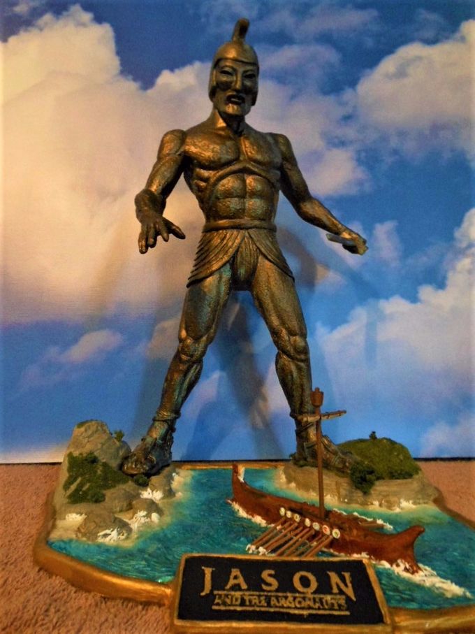 Here is yet another resin kit based on the Talos figure from the 1968 Harryhausen classic, “Jason And The Argonauts”. This is a very nice sculpt by Joe Laudati and retails for around $90.00. 
This is my third Talos build up, one being of Talos posed on the god's jewel case and the other a vinyl version I picked on eBay when I was first starting out in the hobby. That kit had just of the Talos figure and I added the base which, as it turns out, was very close in design to this kit I'm reviewing here although larger.
This kit was a pretty simple affair with very little clean up needed and had about a dozen pieces (not counting the toothpick oars). If I had one complaint about this kit is that the Argo (Jason's ship) was cast into the base which made its painting and installation of the tooth pick oars a little more difficult than it had to be. The mast/sail part seemed a little clunky to me so I made a new one with small dowels and tea bag paper for the sail which I lashed to the cross arm with very thin wires.
 I also built up the land areas a bit more with two part epoxy putty and added ground foam foliage and shrubs to add a little more interest to the scene. I coated the 'water' with a thick clear resin and made the breakers and boat & oar wash with Liquitex model paste.
This is a nice kit for beginners partly due its simplicity and price along with being another beautiful sculpt by Joe Laudati. You can pick one up at Monsters In Motion, an online store that I frequent regularly. Here's their link: https://www.monstersinmotion.com/cart/index.php?main_page=advanced_search_result&search_in_description=0&x=0&y=0&keyword=talos