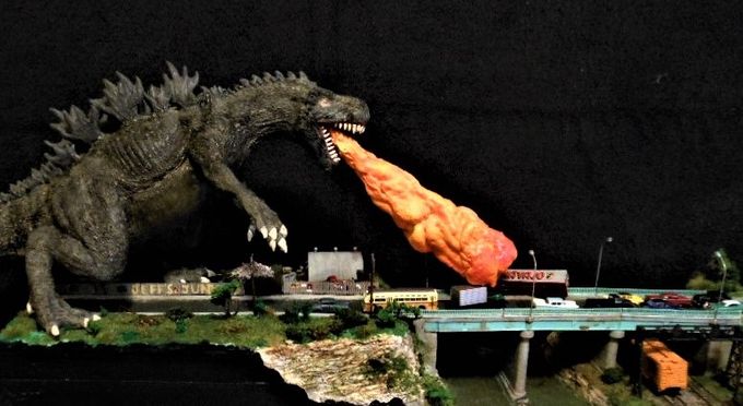 Long shot showing just about the whole scene minus a bit of Godzilla's tail.