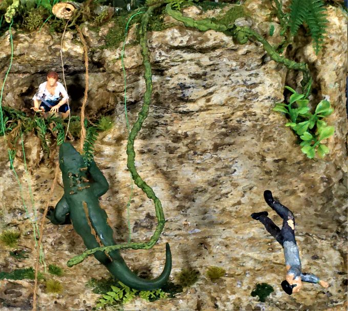 The Driscoll character being menaced by the lizard biped as seen in the film. The lizard is a cut up Komodo dragon toy and the Driscoll character is 3D printed with a knife fashioned from a piece of scrap plastic. The falling figure on the right is handmade using two part epoxy clay with an aluminum wire armature.